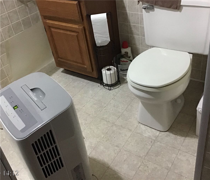 A bathroom with white tiles on white vanity.