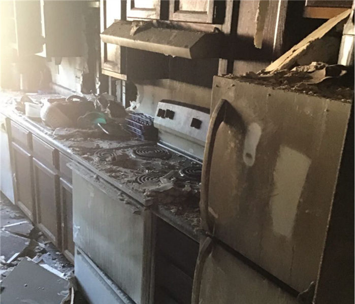 A small kitchen that has been damaged by a fire