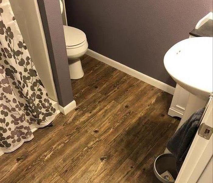 bathroom laminated floors near a sink.