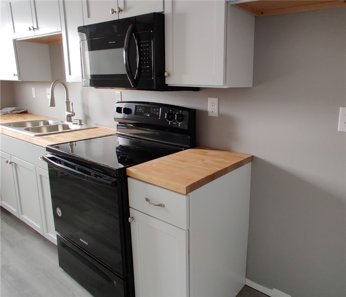 A clean and repaired kitchen with new appliances.