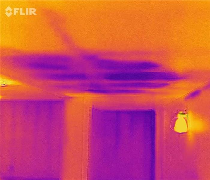 A thermal reading of a basement ceilings with purple and orange being the two colors on this image. 
