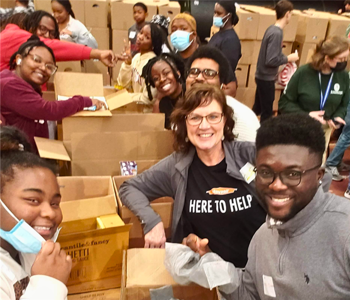 Debbie with volunteers at Pack the Dome with boxes