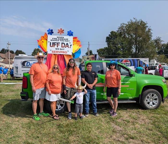 Crew in front of truck parade float