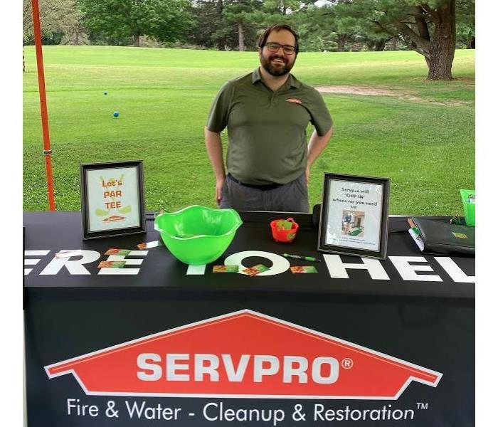 Sam standing behind our SERVPRO table 